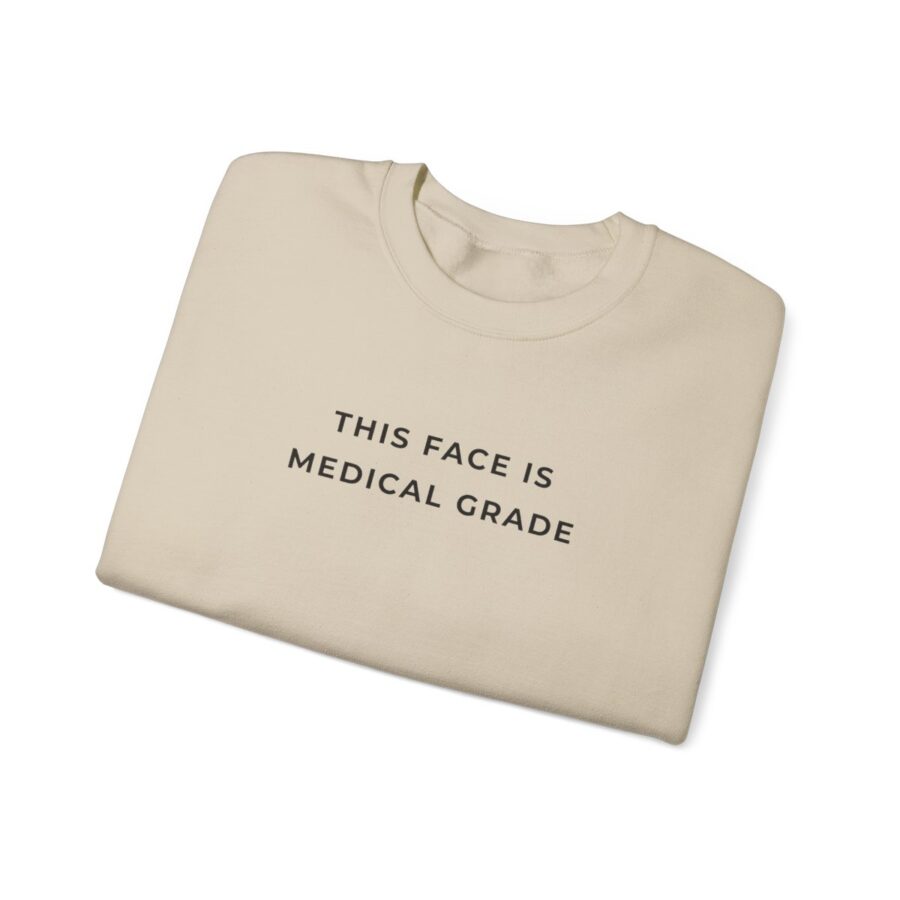 tan sweatshirt with words "this face is medical grade" in black