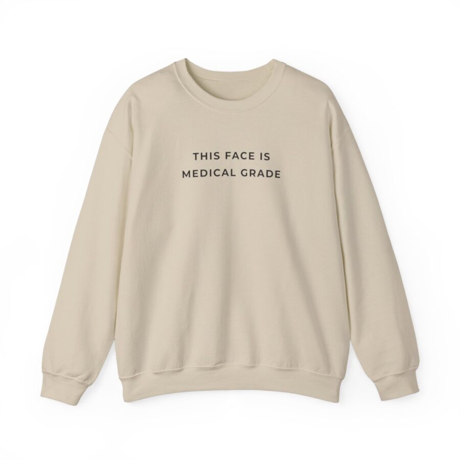 tan sweatshirt with words "this face is medical grade" in black